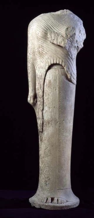 A photograph of a female statue missing its head and one of its arms.