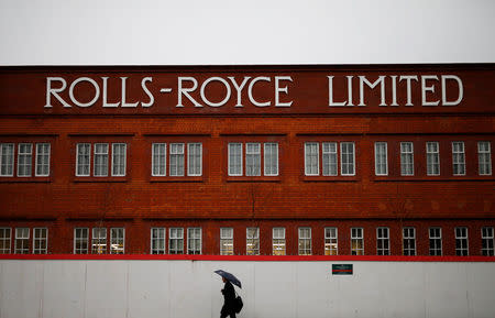 FILE PHOTO: A man walks past a former Rolls Royce site in Derby, Britain February 12, 2016. REUTERS/Darren Staples/File Photo