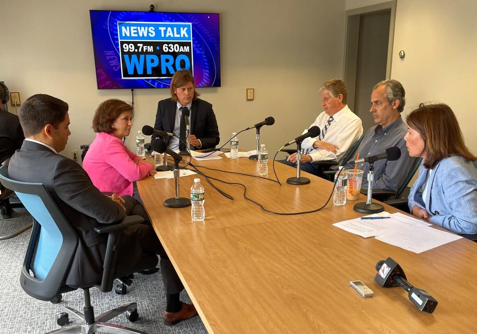 WPRO Radio host Bill Bartholomew, center, moderates Monday's gubernatorial debate among, from left, Luis Daniel Munoz, Nellie Gorbea, Gov. Dan McKee, Matt Brown and Helena Foulkes.