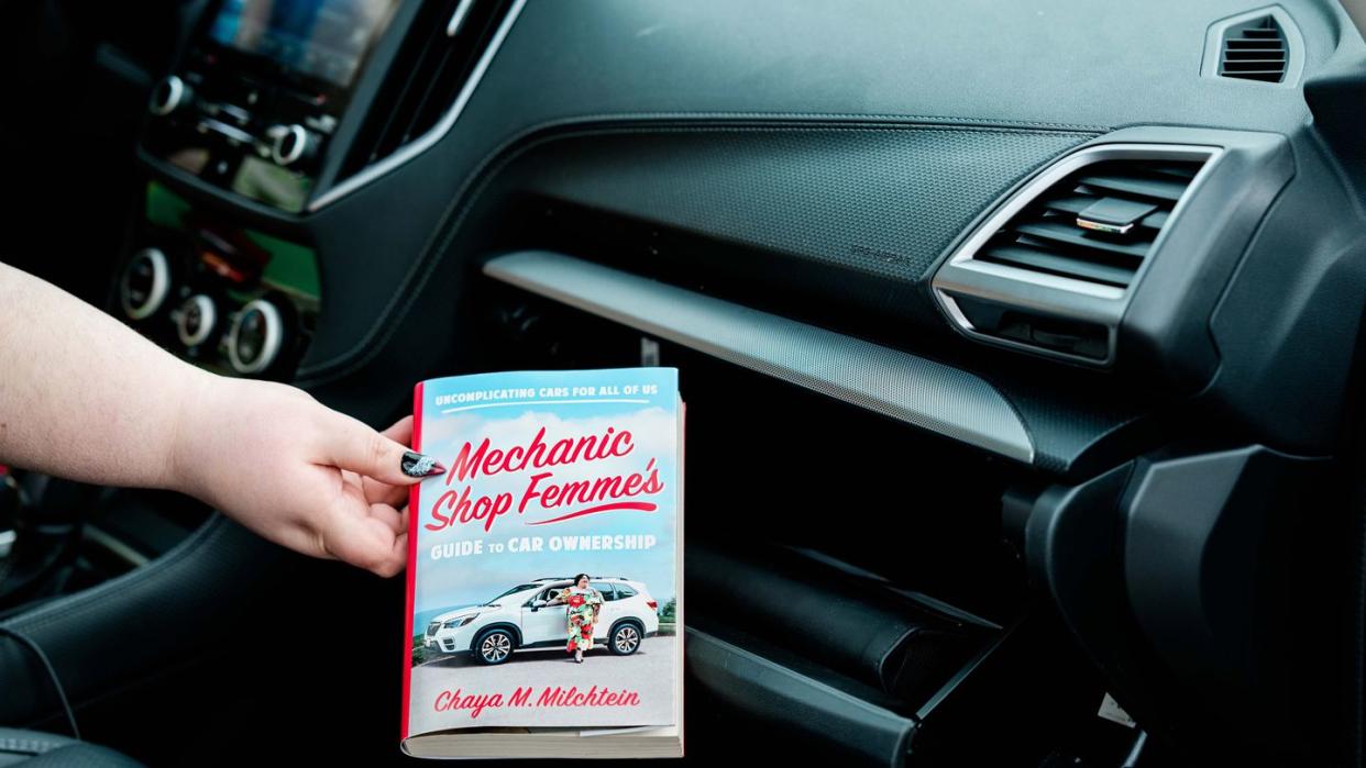 a person holding a book in a car