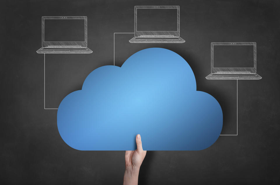 A diagram showing three laptops connecting to a cloud