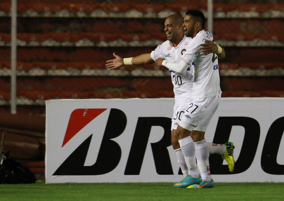 Adriano of Brazil's Atletico Paranaense, left, celebrates with teammate Matias Mirabaje after scoring against Bolivia's The Strongest at a Copa Libertadores soccer match in La Paz, Bolivia, Tuesday, April 8, 2014. (AP Photo/Juan Karita)