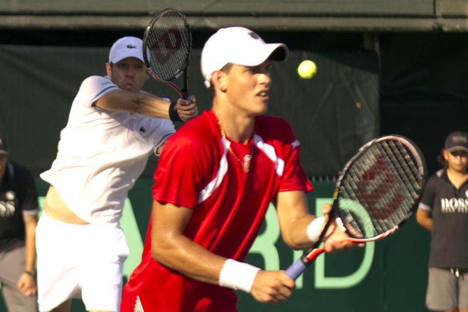 Canadian tennis player Daniel Nestor (L) and Vasek Pospisil (R) return to Israeli tennis team players Jonathan Erlich and Andy Ram during their Davis Cup world group doubles playoff tennis match in Ramat Hasharon near Tel Aviv on September 17, 2011. AFP PHOTO/JACK GUEZ (Photo credit should read JACK GUEZ/AFP/Getty Images)