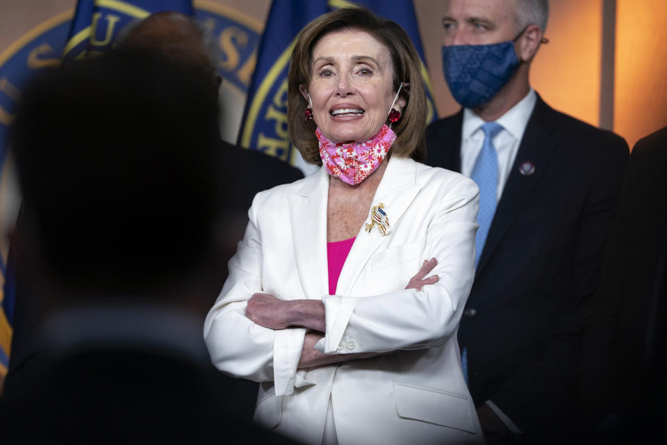 House Speaker Nancy Pelosi of Calif., attends a news conference, Friday, Nov. 19, 2021, after House passage of President Joe Biden's expansive social and environment bill, on Capitol Hill in Washington. Democrats brushed aside months-long divisions and pushed their expansive social and environment bill through a sharply divided House on Friday, as President Joe Biden and his party moved closer to capitalizing on their control of government by funneling its resources toward their top domestic priorities. (AP Photo/Jacquelyn Martin)