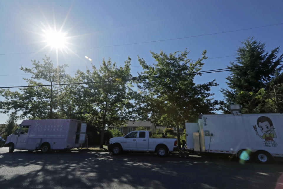 The Dreamy Drinks and YS Street Food food trucks sit parked, Monday, Aug. 10, 2020, near the suburb of Lynnwood, Wash., north of Seattle. Long seen as a feature of city living, food trucks are now finding customers in the suburbs during the coronavirus pandemic as people are working and spending most of their time at home. (AP Photo/Ted S. Warren)