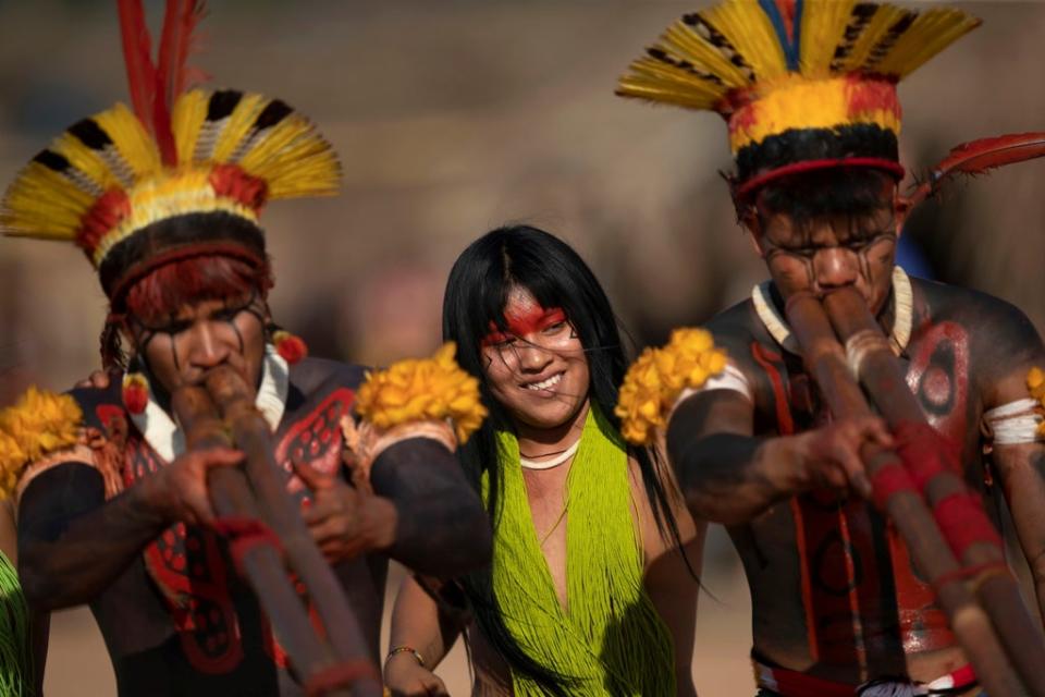 Yawalapiti, Kalapalo and Mehinako people play the urua bamboo flutes as they dance (Reuters)