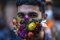 A person smiles as he wears a face mask amid of new coronavirus pandemic during the Diversity parade in Montevideo, Uruguay, Friday, Sept. 25, 2020. The event is held every year to raise awareness and fight against discrimination based on sexual identity and orientation. (AP Photo/Matilde Campodonico)