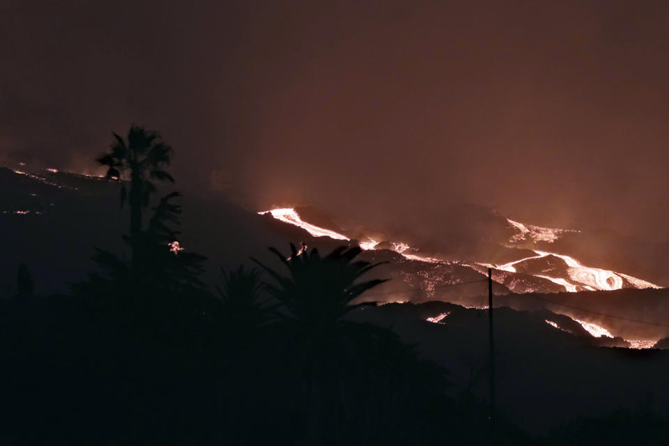 A volcano continues to erupt on the Canary island of La Palma, Spain on Saturday Oct. 16, 2021. Officials say there is no sign that a volcanic eruption on the Spanish island of La Palma is coming to an end, one month after it began. The volcano on one of the Canary Islands off northwest Africa has so far destroyed more than 1,800 buildings, mostly homes. (AP Photo/Daniel Roca)