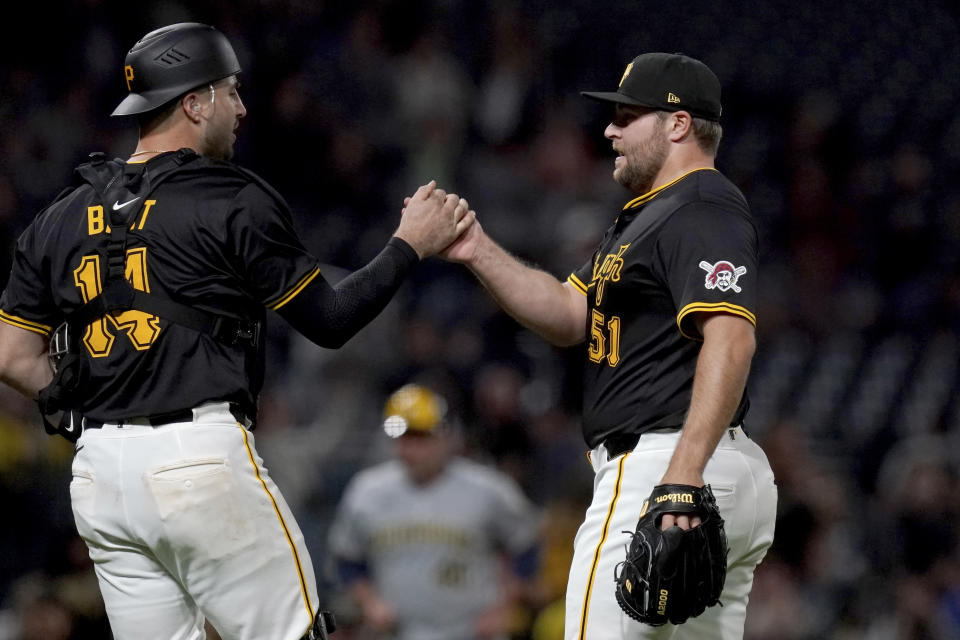 Pittsburgh Pirates relief pitcher David Bednar, right, celebrates with catcher Joey Bart after the team's win against the Milwaukee Brewers in baseball game Tuesday, April 23, 2024, in Pittsburgh. (AP Photo/Matt Freed)