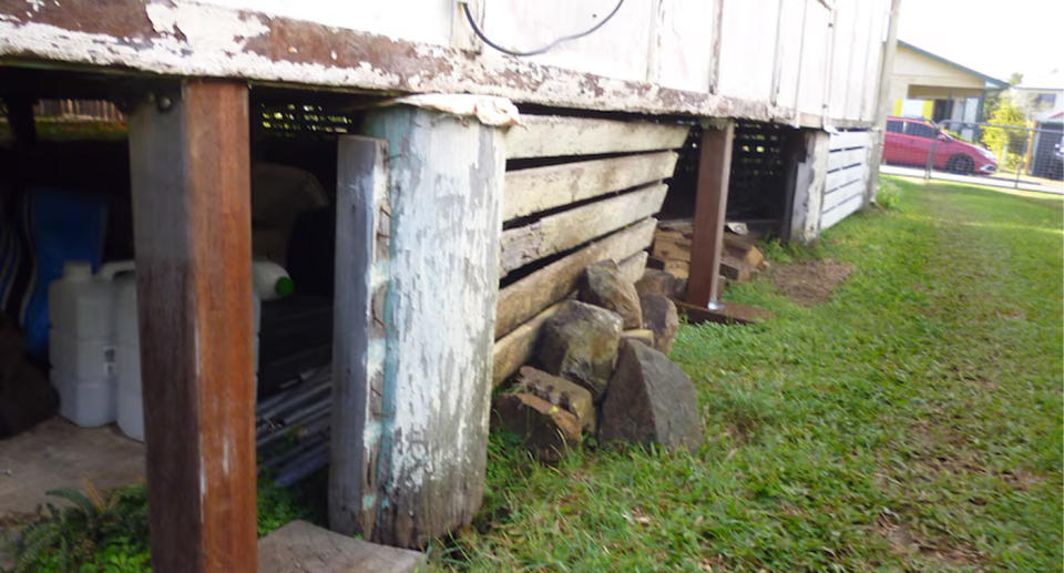 Moreton Bay property being held up with rocks. 