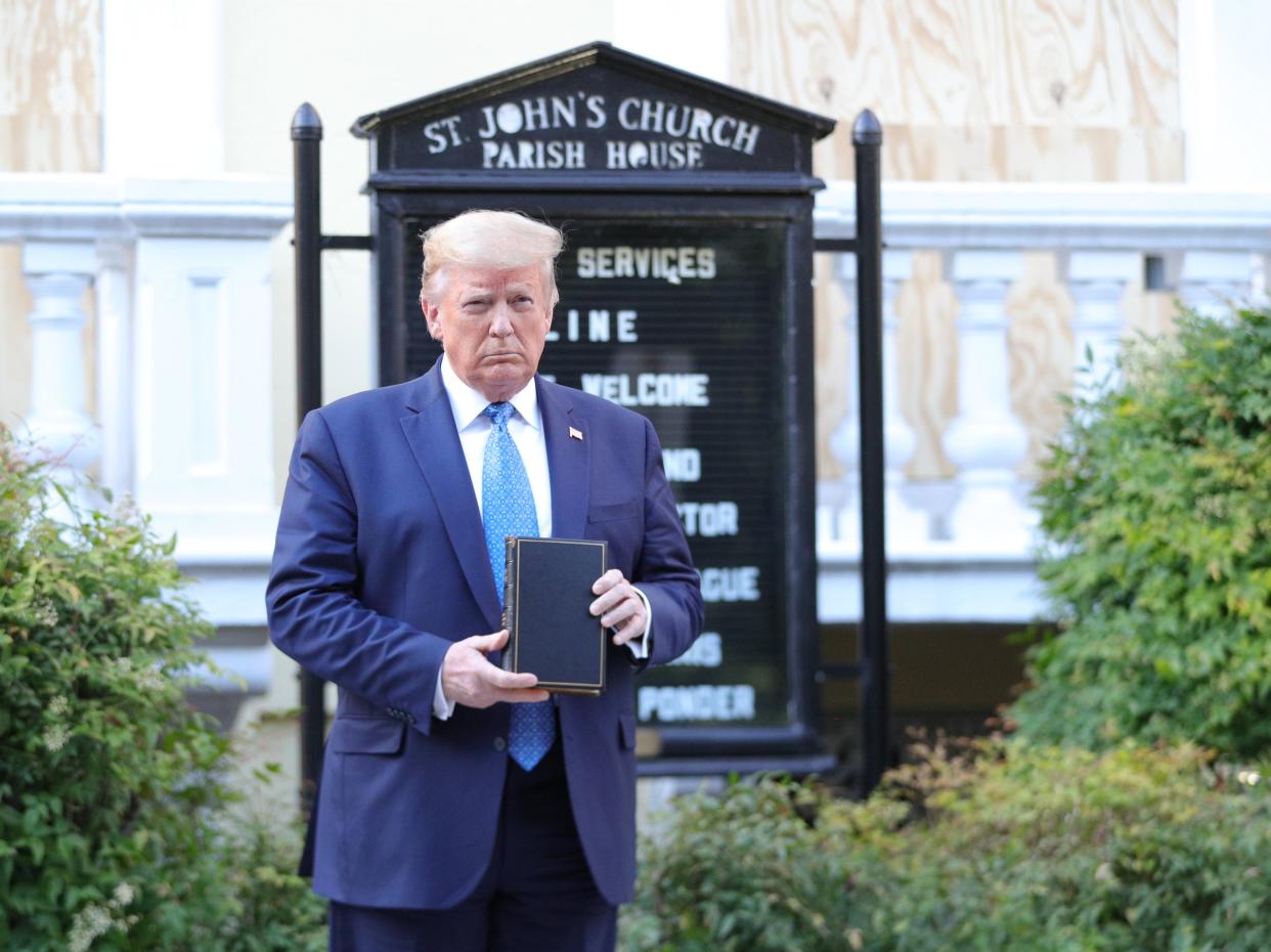 US president Donald Trump holds up a Bible as he stands in front of St. John’s Episcopal Church across from the White House after walking there for a photo opportunity during ongoing protests over racial inequality in the wake of the death of George Floyd while in Minneapolis police custody, at the White House in Washington on 1 June 2020 ((Reuters))