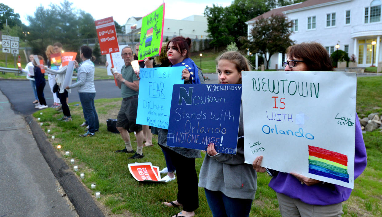 Nearly two dozen protesters showed up in front of the National Shooting Sports Foundation in Newtown, Conn., for a candlelight vigil to remember the victims of the Orlando mass shooting, which took place June 12, 2016. (Photo: Peter Casolino/Hartford Courant/TNS via Getty Images)