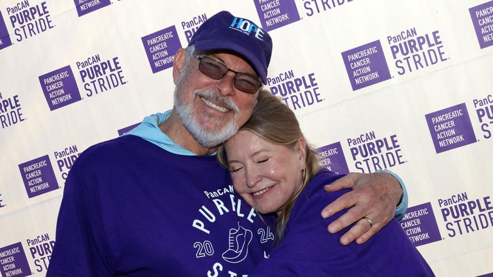 Jonathan Frakes embracing Lisa Niemi Swayze