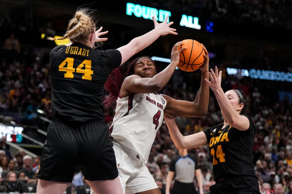 Mar 31, 2023; Dallas, TX, USA; South Carolina Gamecocks forward Aliyah Boston (4) controls the ball against Iowa Hawkeyes forward Addison O'Grady (44) and guard Gabbie Marshall (24) in the second half in semifinals of the women's Final Four of the 2023 NCAA Tournament at American Airlines Center. Mandatory Credit: Kirby Lee-USA TODAY Sports