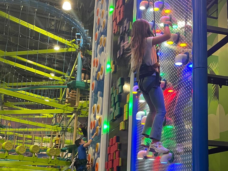 The author's daughter climbing on a light-up wall in Kalahari