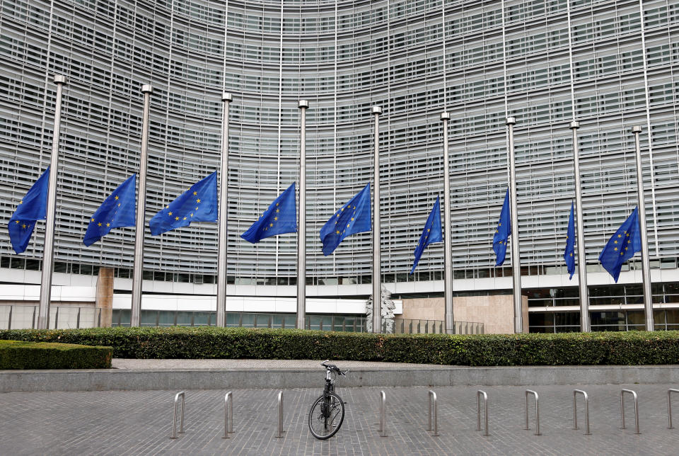 European Union flags are lowered at half-staff outside the European Commission headquarters in Brussels, Belgium.