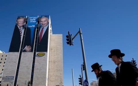 An election campaign billboard shows Israeli Prime Minister Benjamin Netanyahu, right, and US President Donald Trump in Jerusalem - Credit: AP Photo/Oded Balilty