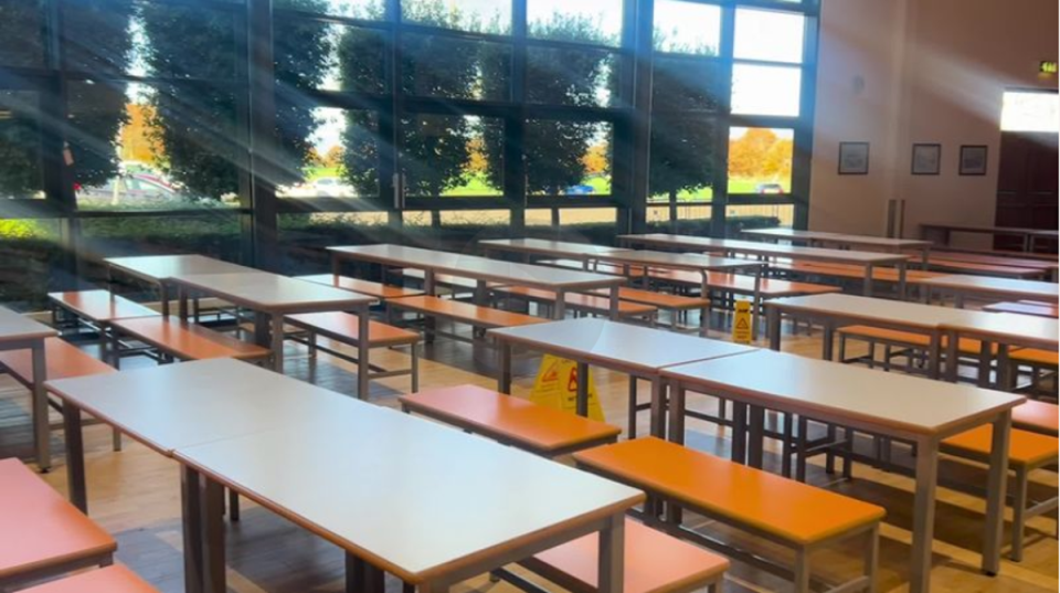 Families have their food provided at the former school canteen (The Independent)