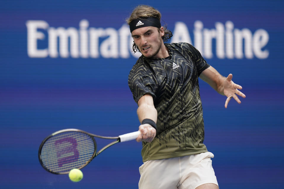 Stefanos Tsitsipas, of Greece, returns a shot to Andy Murray, of Great Britain, during the first round of the US Open tennis championships, Monday, Aug. 30, 2021, in New York. (AP Photo/Seth Wenig)