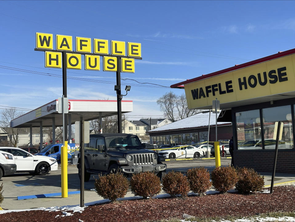 A police car is shown near a Waffle House in Indianapolis Monday, Feb. 19, 2024, where at least one person was killed and several injured. (AP Photo/Isabella Volmert)