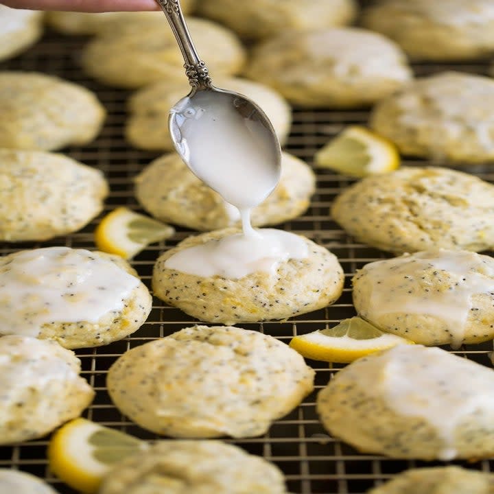 Pouring icing onto cookies.
