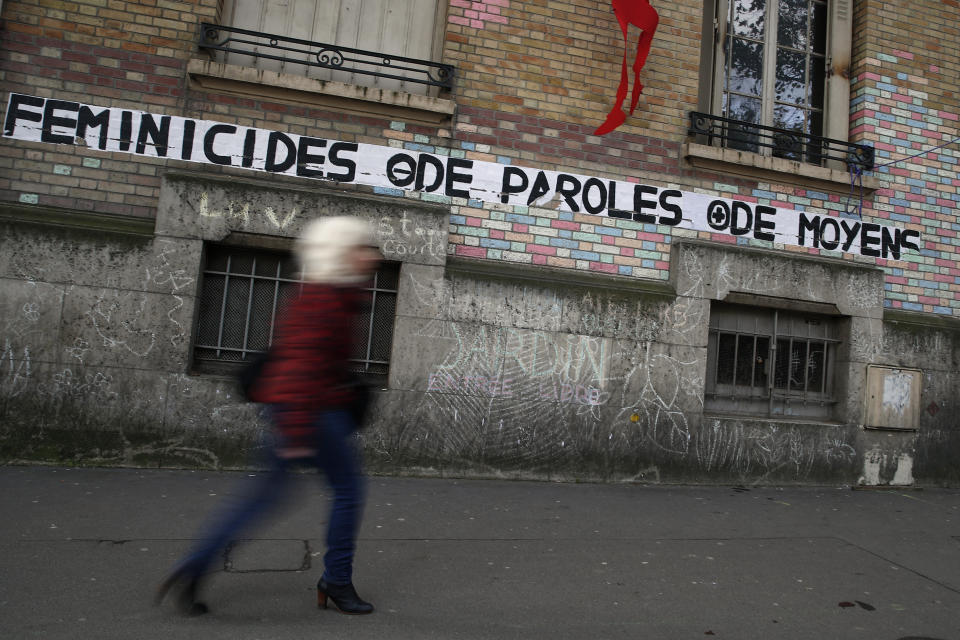 A poster reads "Feminicide, less speeches, more money" in Paris, Wednesday, Nov. 6, 2019. France, a country that has prided itself on gender equality, is beginning to pay serious attention to its yet-intractable problem of domestic violence. (AP Photo/Francois Mori)