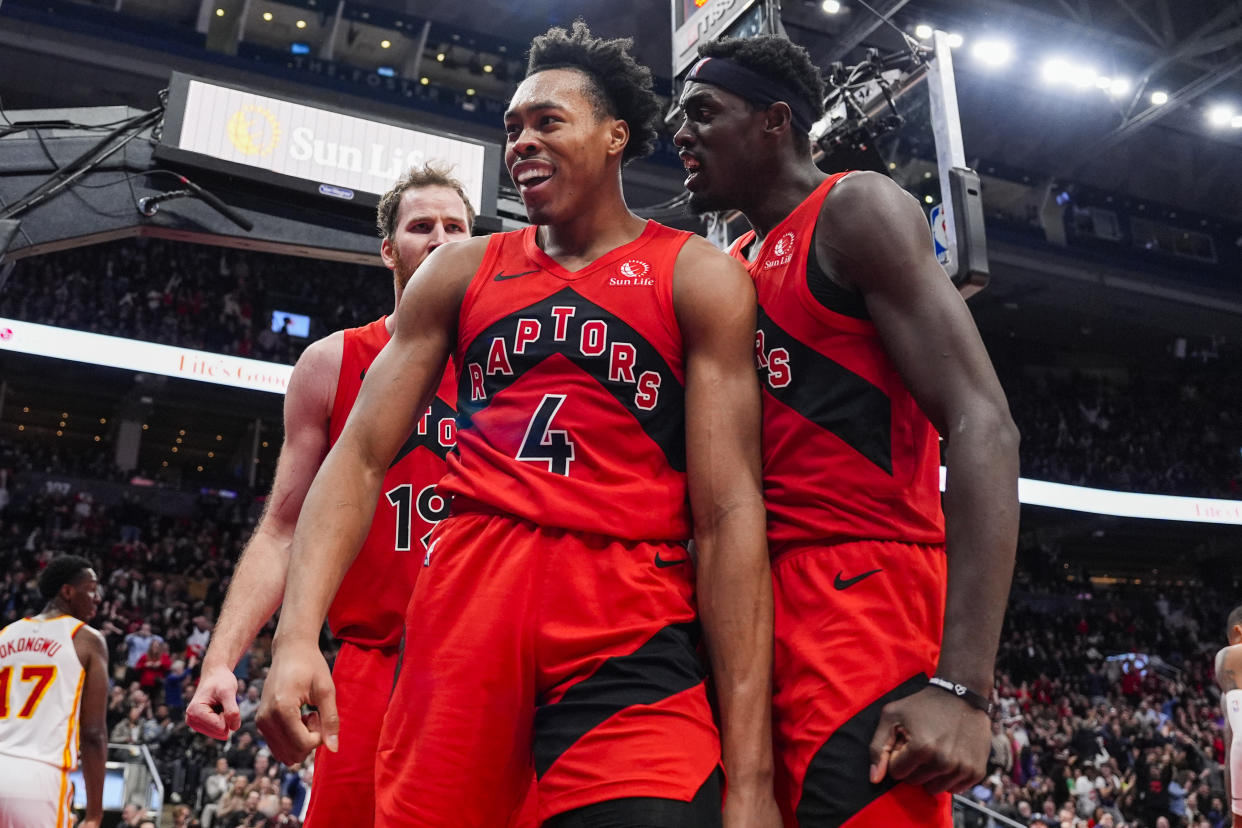 Toronto's Scottie Barnes celebrates with Pascal Siakam after making a basket against the Atlanta Hawks at Scotiabank Arena in Toronto, on Dec. 13, 2023. (Photo by Andrew Lahodynskyj/Getty Images)