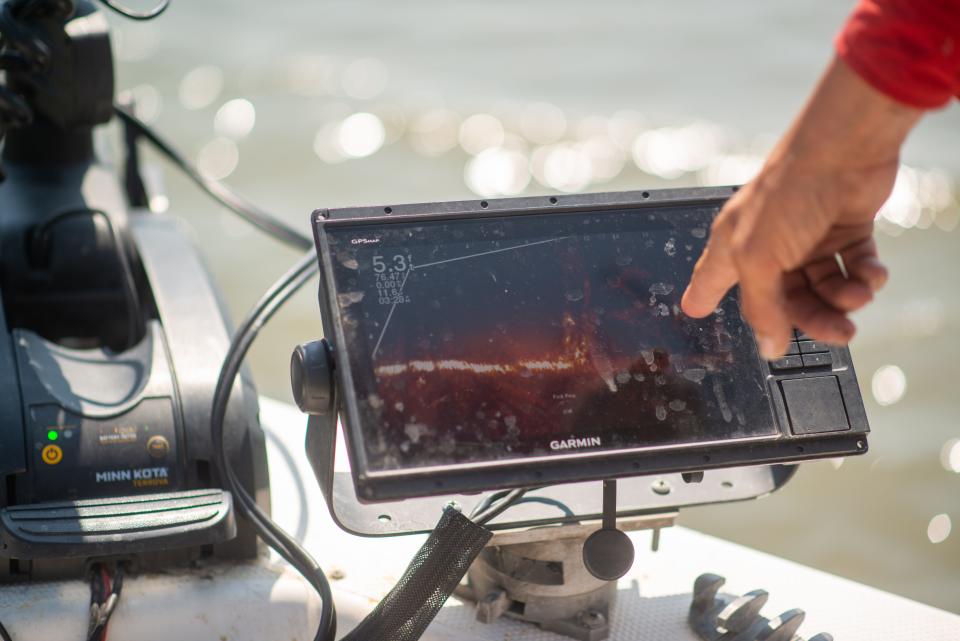 Ball-like figures on a Garmin live sonar screen are pointed out by Joe Bragg as crappie hiding under logs at Milford Lake. Bragg said it isn't difficult to learn how to use the system, which has made fishing more like hunting because you can see exactly where the fish are.