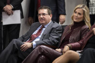 FILE - Washington Redskins owner Dan Snyder, left, and his wife Tanya Snyder, listen to head coach Ron Rivera during a news conference at the team's NFL football training facility in Ashburn, Va., Thursday, Jan. 2, 2020. The Washington Commanders are denying the contents of a report about the team’s sale process and demands being made by owner Dan Snyder. The team in a statement late Monday, Feb. 27, 2023, said a story published hours earlier by The Washington Post is “simply untrue.” (AP Photo/Alex Brandon, File)