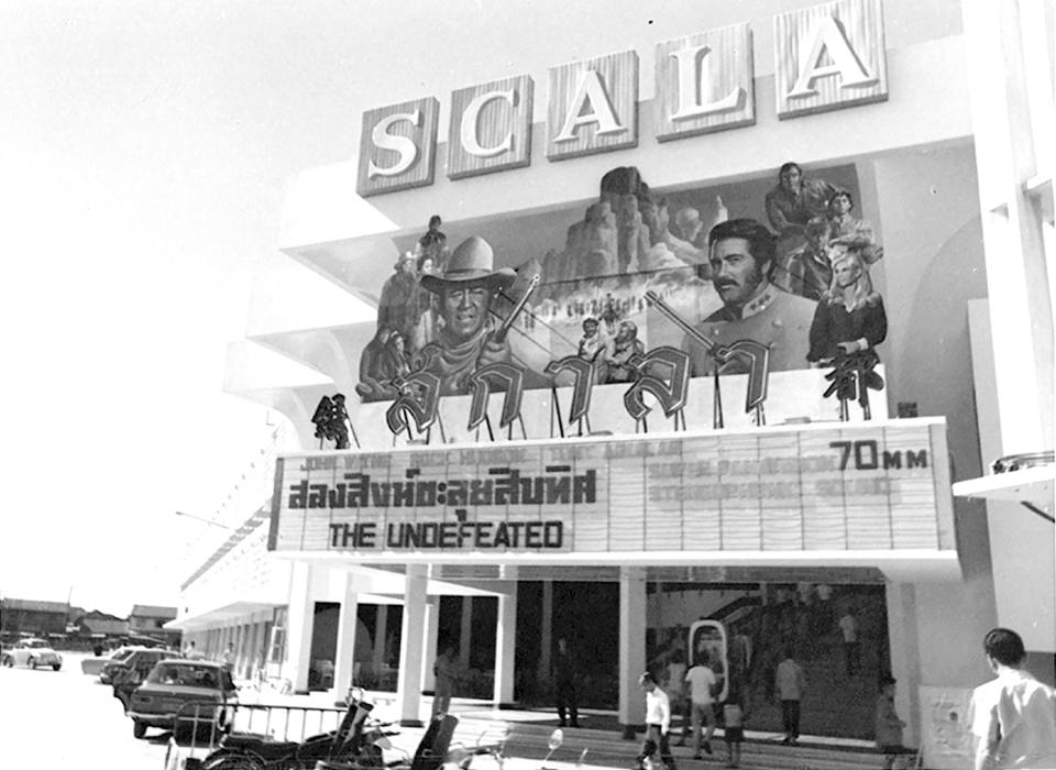 In this undated black and white photo released by Scala Movie Theater, the Scala theater marquee shows "The Undefeated," an American western movie that starred John Wayne and Rock Hudson, the first film screened at the theater when it opened on Dec. 31, 1969 in Bangkok, Thailand. The Scala theater has shut its doors after 51 years as a shrine for Thai movie-goers. (Scala Movie Theater via AP)