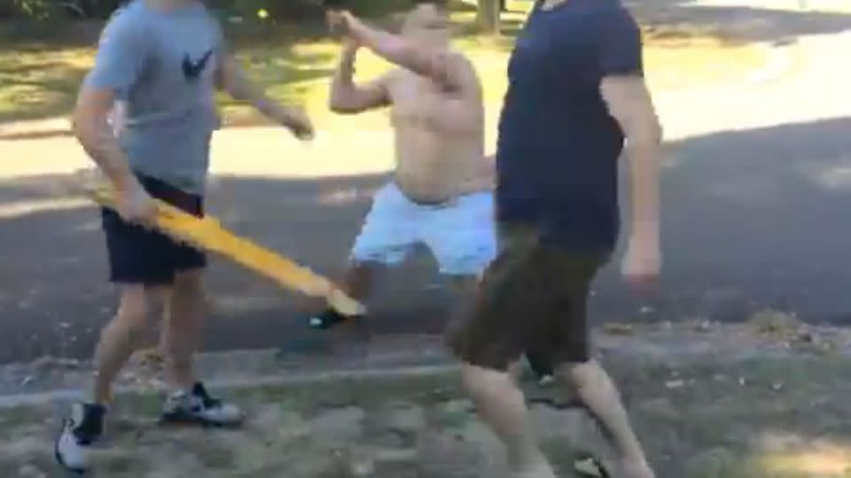 One of the boys swings at the man, knocking him to the ground. Photo: Facebook