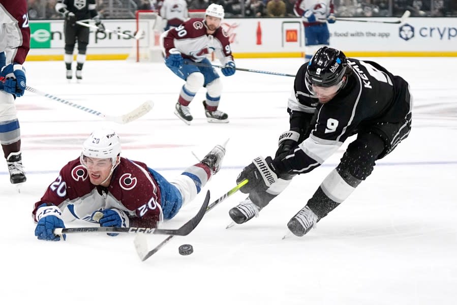 Colorado Avalanche center Ross Colton, left, dives for the puck as Los Angeles Kings center Adrian Kempe takes it during the third period of an NHL hockey game Wednesday, Oct. 11, 2023, in Los Angeles. (AP Photo/Mark J. Terrill)