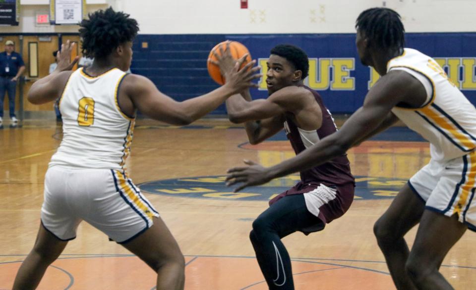 Sarasota Riverview's Jason Jackson looks to shoot against Winter Haven's Jamie Phillips Jr. (0) and Dylan James on Thurday night in the Class 7A, Region 3 quarterfinals at the Jack Deedrick Gymnasium.