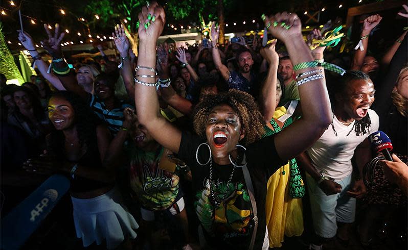 Jamaican fans celebrate after Bolt wins his seventh Olympic gold medal. Photo: Getty