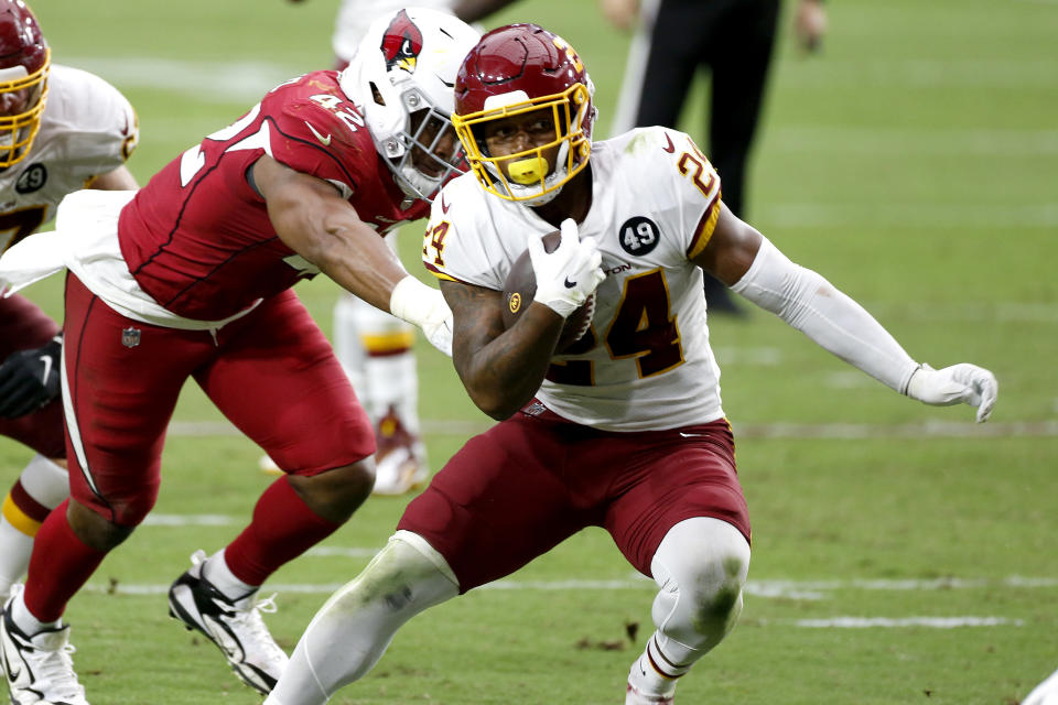 Washington Football Team running back Antonio Gibson (24) runs for a touchdown as Arizona Cardinals outside linebacker Devon Kennard (42) defends during the second half of an NFL football game, Sunday, Sept. 20, 2020, in Glendale, Ariz. (AP Photo/Darryl Webb)