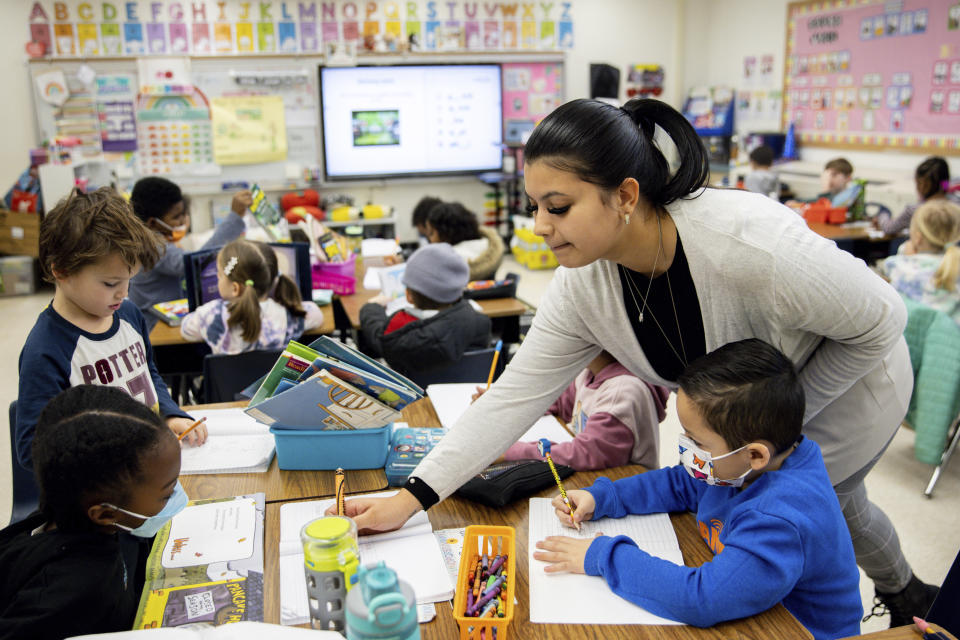 Christine Ramroop, who graduated from Bowie State University in 2020, teaches first graders during their warm-up for the day at Whitehall Elementary School, Tuesday, Jan. 24, 2023, in Bowie, Md. (AP Photo/Julia Nikhinson)