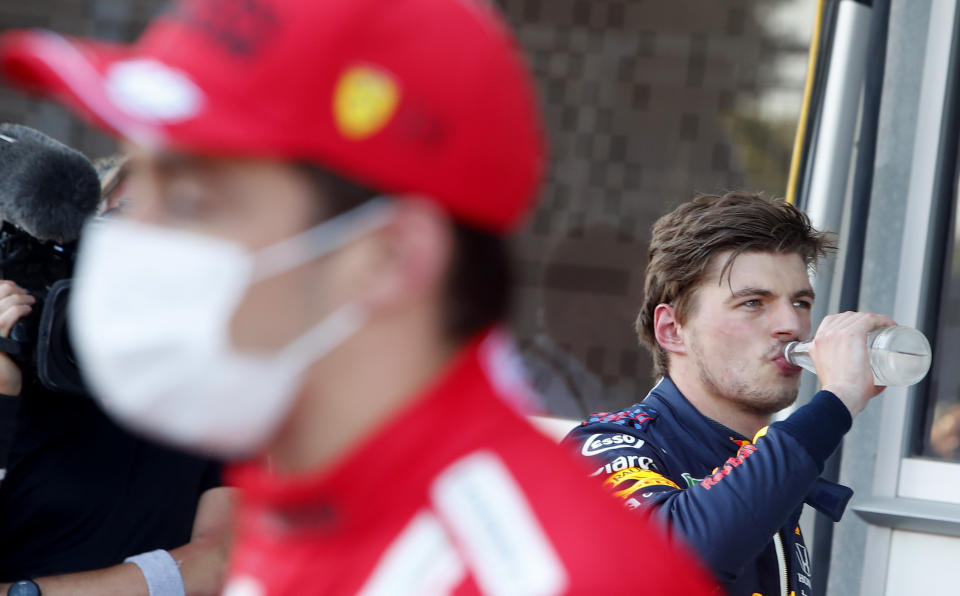 Ferrari driver Charles Leclerc of Monaco, left, and Red Bull driver Max Verstappen of the Netherlands after the qualifying session at the Baku Formula One city circuit in Baku, Azerbaijan, Saturday, June 5, 2021. The Azerbaijan Formula One Grand Prix will take place on Sunday. (Maxim Shemetov, Pool via AP)