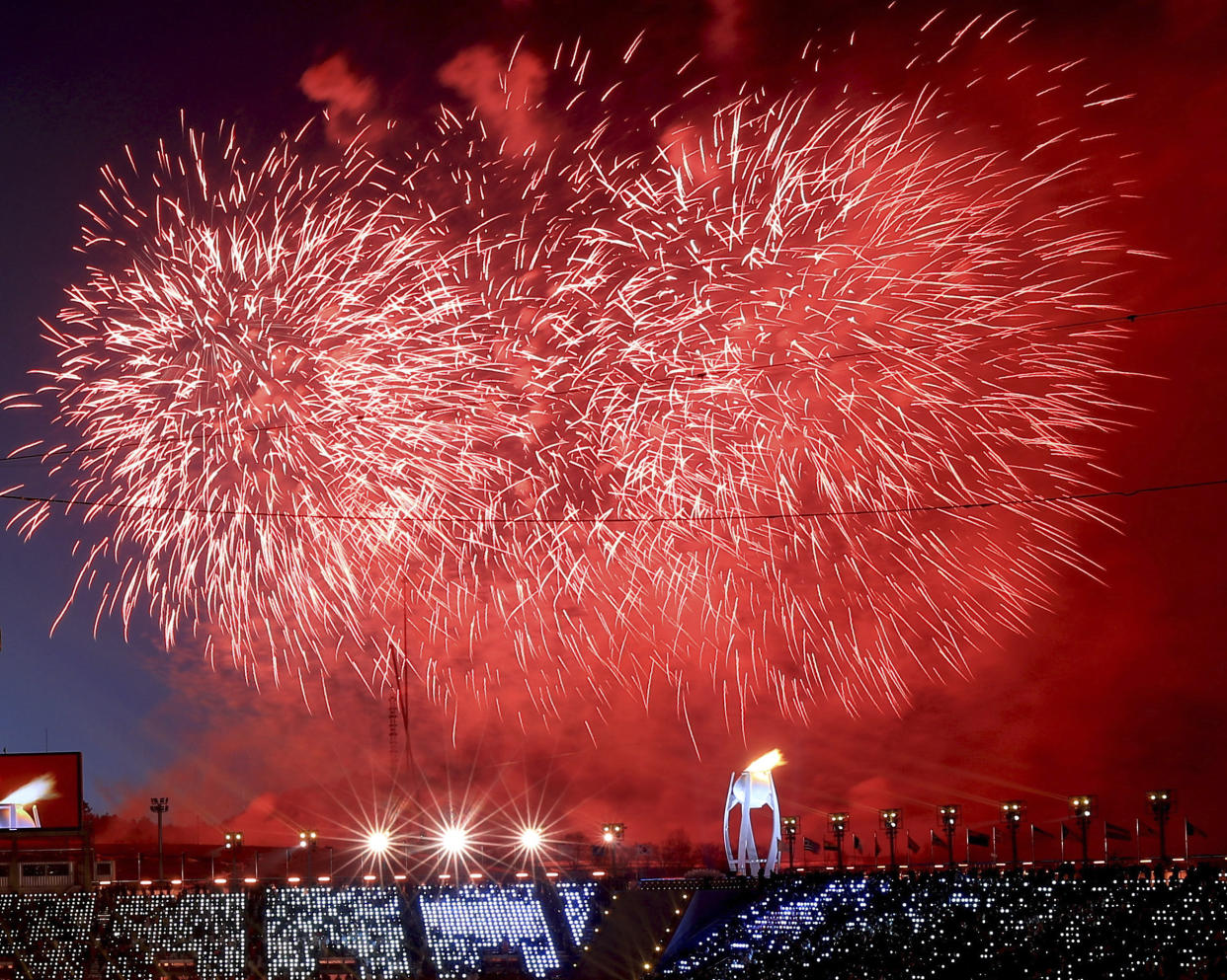 Fireworks detonate after the Olympic flame was lit during the opening ceremony (AP photo)