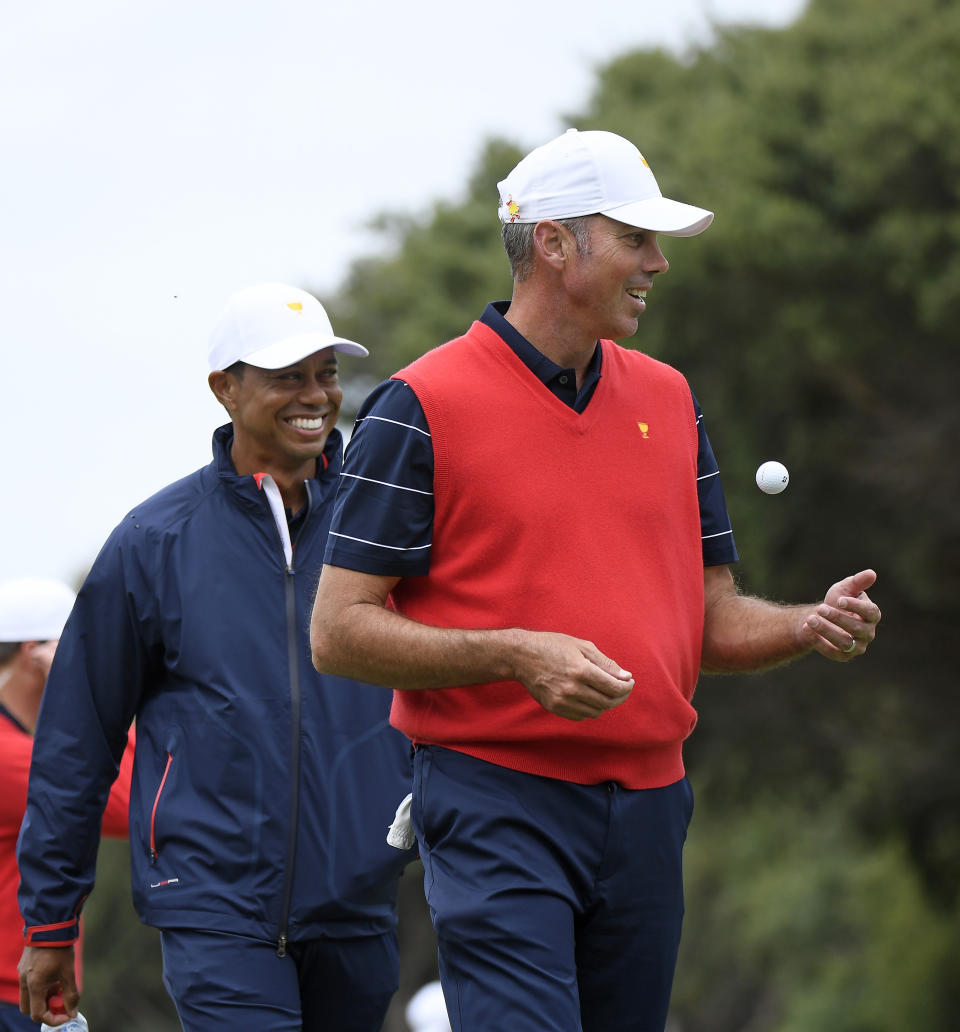 USA team captain Tiger Woods, left, and Matt Kuchar smile during a practice round ahead of the President's Cup golf tournament in Melbourne, Australia, Wednesday, Dec. 11, 2019. (AP Photo/Andy Brownbill)