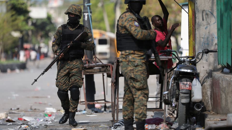 Police officers patrol in Port-au-Prince on March 9 as Haiti remains in a state of emergency. - Ralph Tedy Erol/Reuters