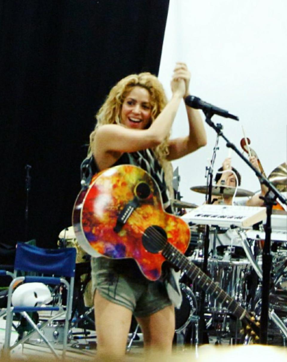 Shakira performs with a guitar designed by Dominic Pangborn.