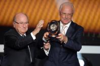 ZURICH, SWITZERLAND - JANUARY 07: Franz Beckenbauer receives the FIFA Presential award 2012 trophy by Joseph Blatter, FIFA president (L) at Congress House on January 7, 2013 in Zurich, Switzerland. (Photo by Christof Koepsel/Getty Images)