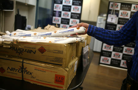 A police chief handles a portion of 200 kilograms of explosive emulsion, regularly used by thieves during bank robberies, seized by State Department of Criminal Investigations in Sao Paulo, Brazil February 8, 2019. REUTERS/Amanda Perobelli