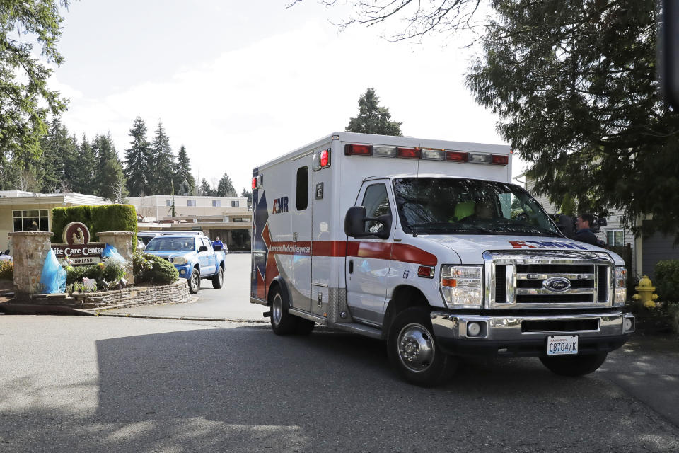 In this March 12, 2020 photo, an ambulance leaves Life Care Center in Kirkland, Wash., which has been at the center of the COVID-19 coronavirus outbreak in the state. Residents of assisted living facilities and their loved ones are facing a grim situation as the coronavirus spreads across the country, placing elderly people especially at risk. (AP Photo/Ted S. Warren)