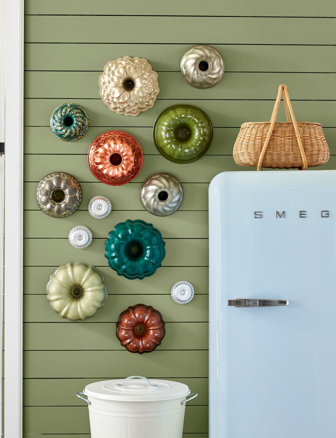 wall with colorful bundt pans hung as decoration