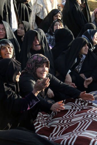 Iranians mourn over the covered bodies of loved ones in the village Baje-Baj, near the town of Varzaqan. Iran has stepped up relief operations in shattered villages in its northeast after saying rescue operations were completed following a double earthquake which cost 227 lives and injured 1,380 people