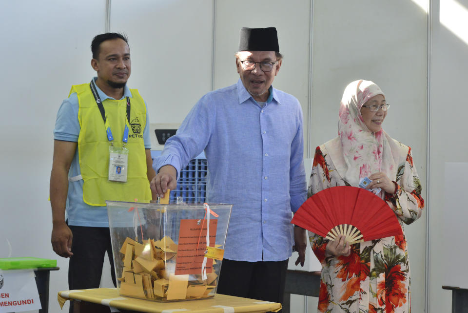 Malaysian Prime Minister Anwar Ibrahim, center, and his wife Wan Azizah, right, cast his ballot during the election at a polling station in Seberang Perai, Penang state,, Malaysia Saturday, Aug. 12, 2023. Voting began Saturday in crucial state elections in Malaysia, where Prime Minister Anwar Ibrahim's multi-coalition government is seeking to strengthen its hold against a strong Islamic opposition. (AP Photo/Vincent Thian)