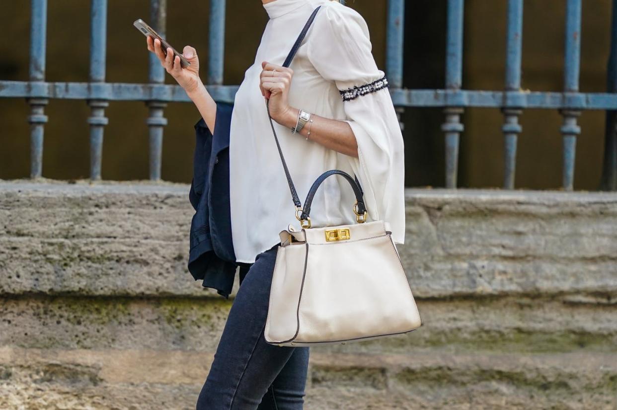 <span class="caption">Watch out, Karen coming through.</span> <span class="attribution"><a class="link " href="https://www.gettyimages.com/detail/news-photo/passerby-wears-a-white-fendi-bag-a-white-flowing-top-a-news-photo/1243898427?adppopup=true" rel="nofollow noopener" target="_blank" data-ylk="slk:Edward Berthelot/Getty Images;elm:context_link;itc:0;sec:content-canvas">Edward Berthelot/Getty Images</a></span>