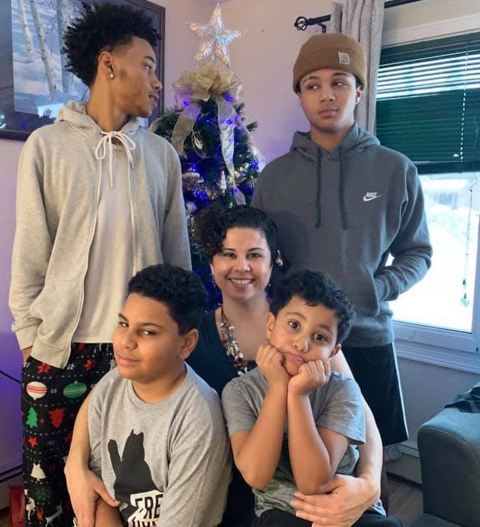 Yatibaey Evans sits surrounded by her four sons.