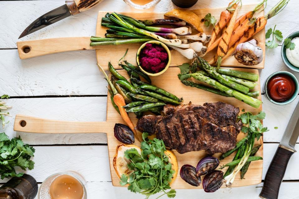 summer bbq meal organic roasted beef meat and vegetables, picnic table top view